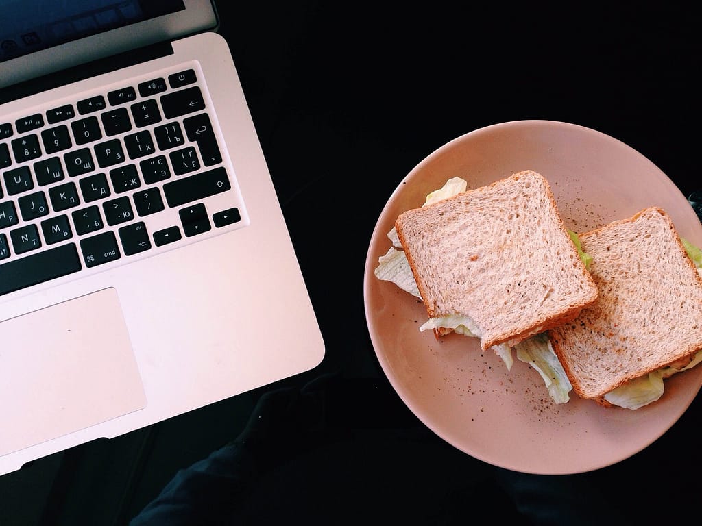 sandwich next to laptop 